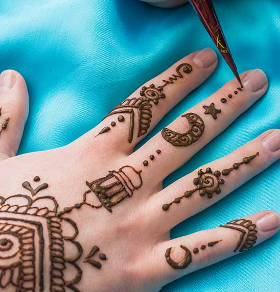 Premium Photo | Artist applying floral henna tattoo on women hands design  for beauty